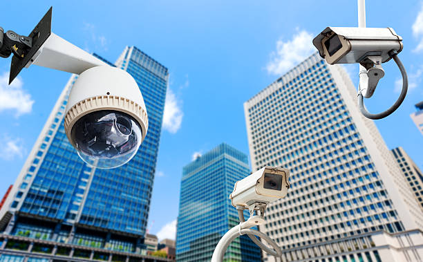 istock CCTV Camera or surveillance oeprating with building in backgroun 492498535