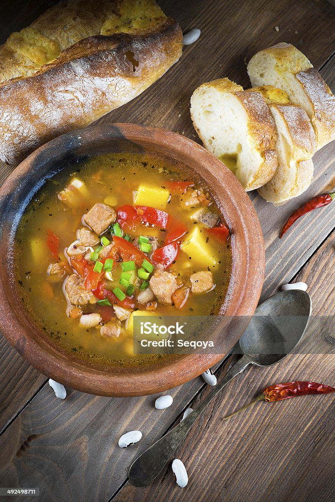 Hungarian goulash with beans and peppers Hungarian goulash with beans and peppers on wooden board Beef Stock Photo