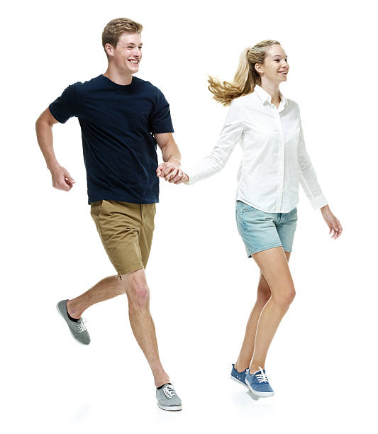 istock Smiling couple holding hands and running 492508216