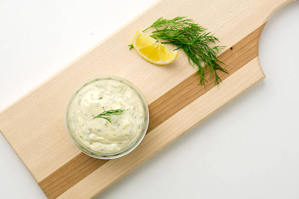 istock Tartar sauce on a wooden serving board top view 492508620