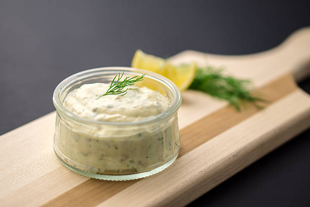 Tartare sauce dip Homemade tartar sauce made of fresh mayonnaise, lemon and various herbs, served in a glass dipping bowl on a wooden serving board. This classic sauce is great with fish and seafood but can also be used in many dishes. ranch dressing stock pictures, royalty-free photos & images