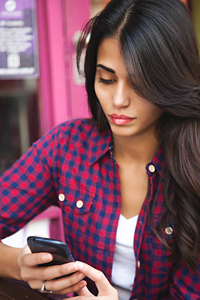 istock attractive young woman texting 492509550