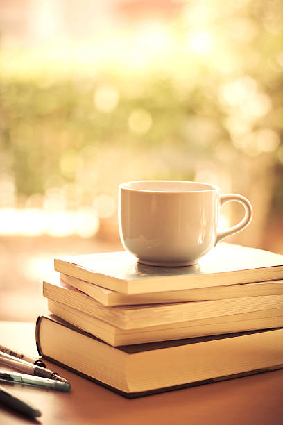 istock selective focus of white coffee cup and  books stacking 492509578