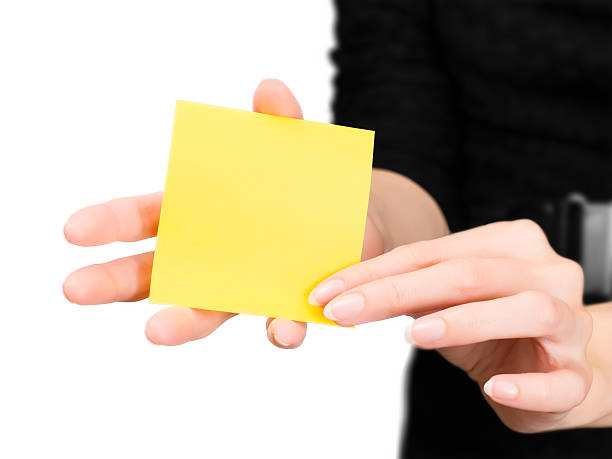 istock Woman hands with blurred silhouette holding memo stick 492511672