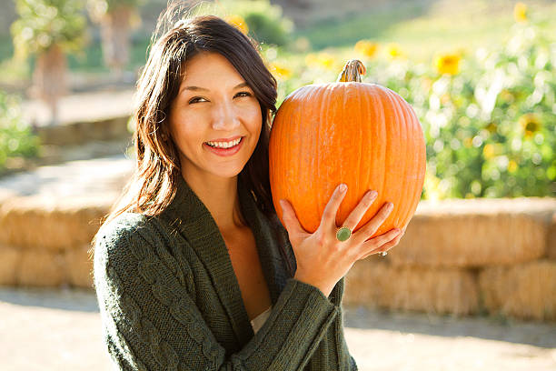 Woman Holding a Pumpkin