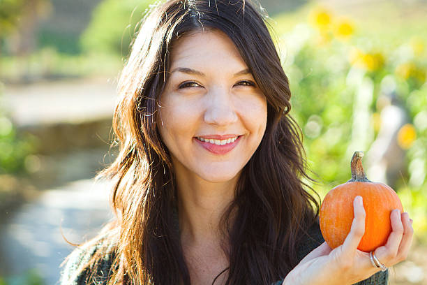 istock Woman Holding a Pumpkin 492512050