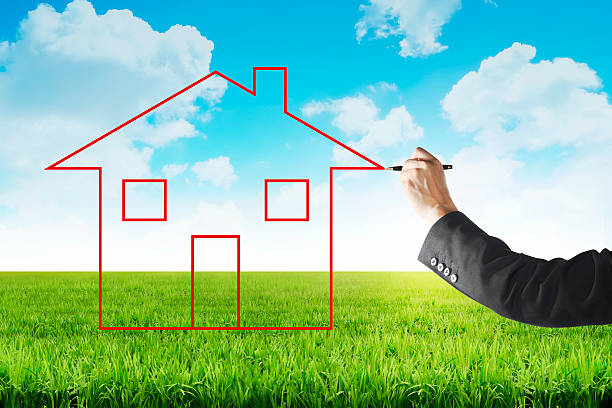 istock Business man drawing house on the meadow 492512626