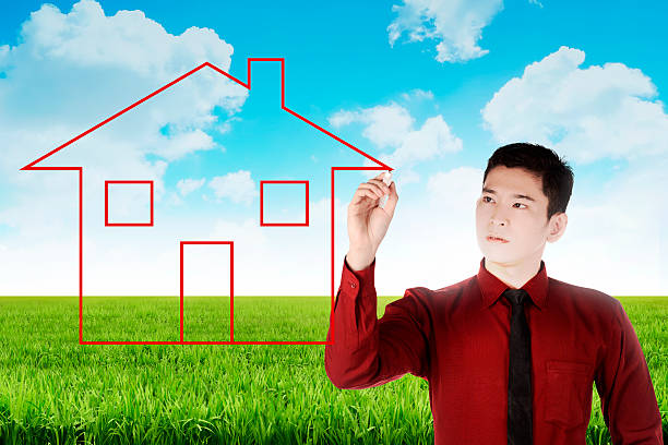 istock Business man drawing house on the meadow 492512716