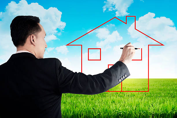 istock Business man drawing house on the meadow 492512764