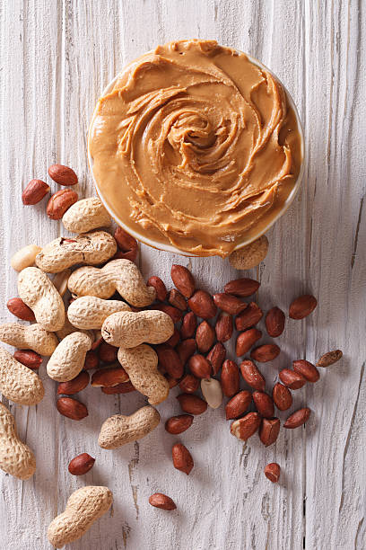 istock Delicious fresh peanut butter close-up vertical top view 492516332