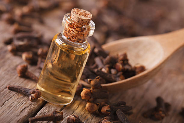 istock Clove oil in a bottle close-up on the table, rustic 492516504