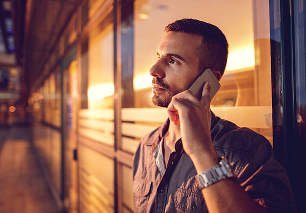 istock Young businessman talking on cell phone and looking away. 492516786