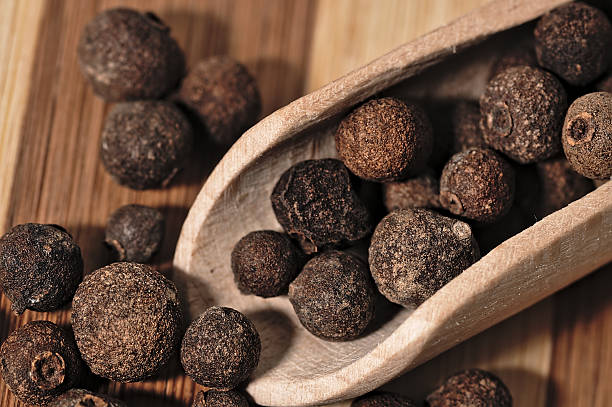 istock Grains allspice on a wooden board. 492520586