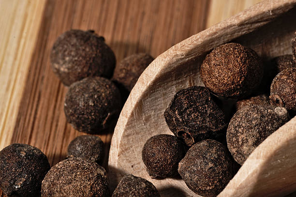 istock Grains allspice on a wooden board. 492520916