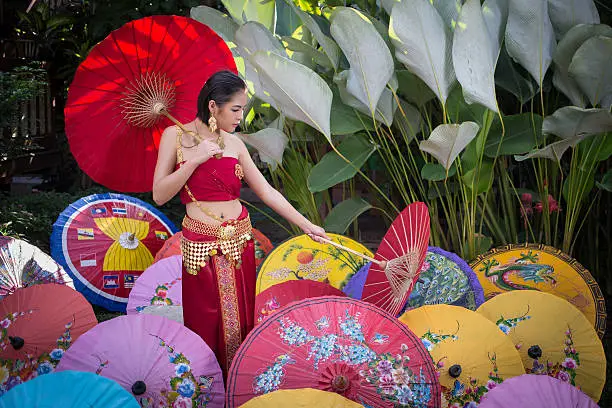 Thai Woman In Traditional Costume Of Thailand with umbrella