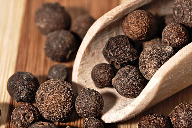 istock Grains allspice on a wooden board. 492521570