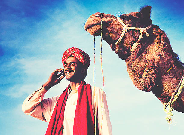 istock Indian Man On the Phone Camel Communication Concept 492521996