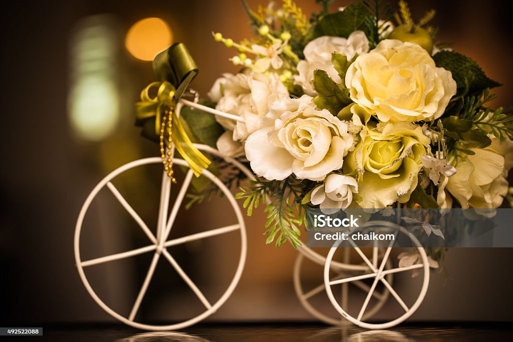 Wooden bicycle with  flowers Wooden bicycle toy for decorative with artificial flowers 2015 Stock Photo