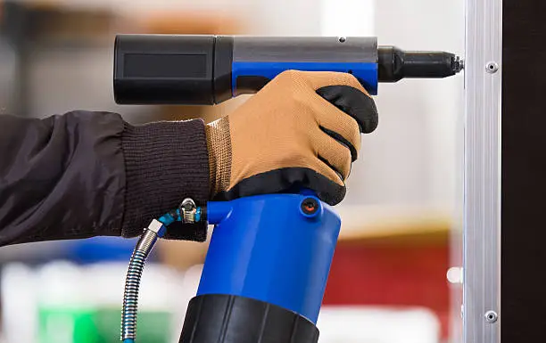 hands hold electric drill in workshops