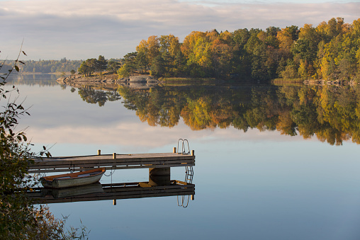 Morning light at the lake boat and jetty in sweden nature