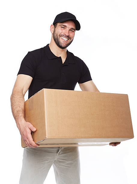 istock Smiling delivery man giving cardbox 492526759