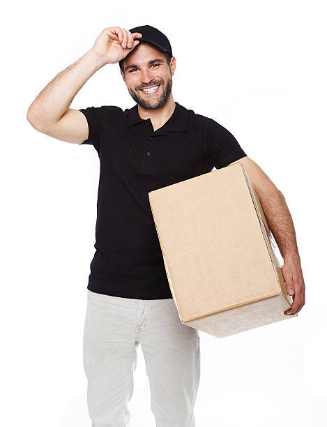 istock Smiling delivery man giving cardbox 492526791