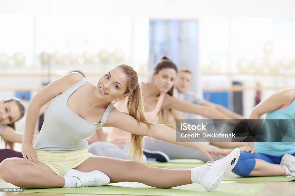 Stretching Women doing stretching in fitness club Active Lifestyle Stock Photo
