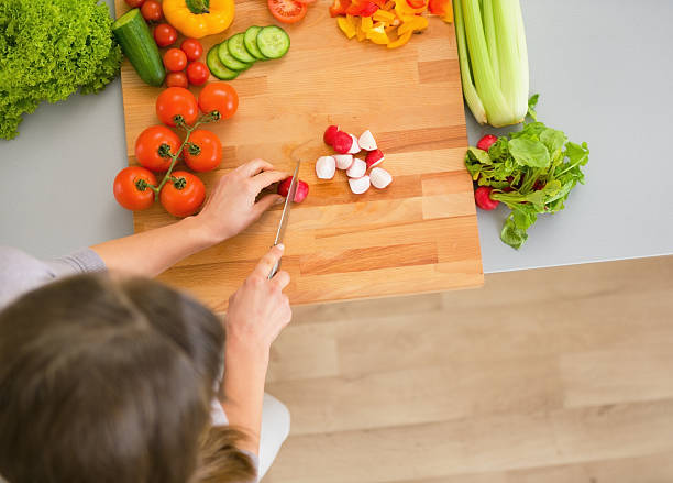 istock young housewife cutting vegetables 492528429