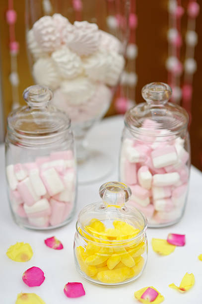 istock Yellow fruit candy and marshmallow in glass jars 492528705