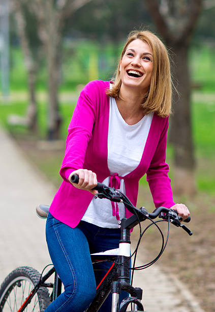 istock woman on bicycle in the park 492529959