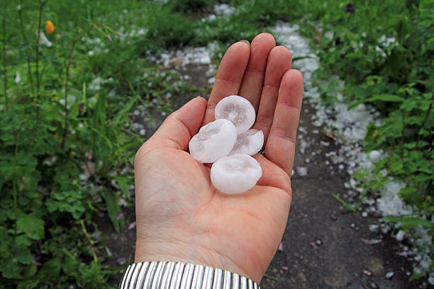 big hailstones - moving toward hailing human hand here стоковые фото и изображения