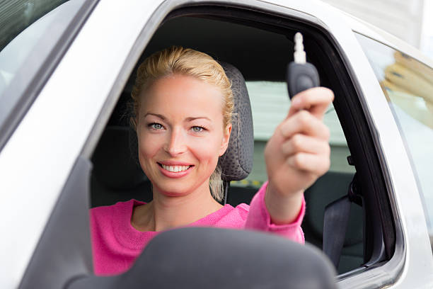 istock Woman driver showing car keys. 492530791