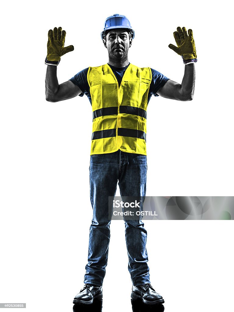 construction worker signaling stop gesture silhouette one construction worker signaling stop gesture with safety vest silhouette isolated in white background Adult Stock Photo