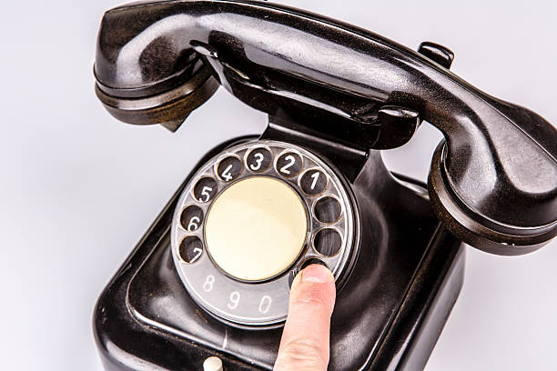 istock Old black phone with dust and scratches on white background 492532341