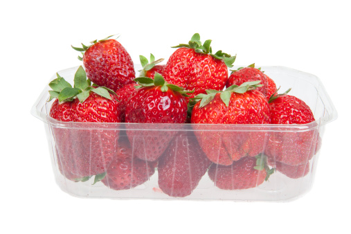 Fresh strawberries in plastic box, isolated on white