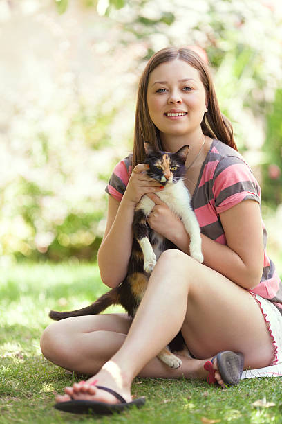 istock Young girl plays with cat 492533533