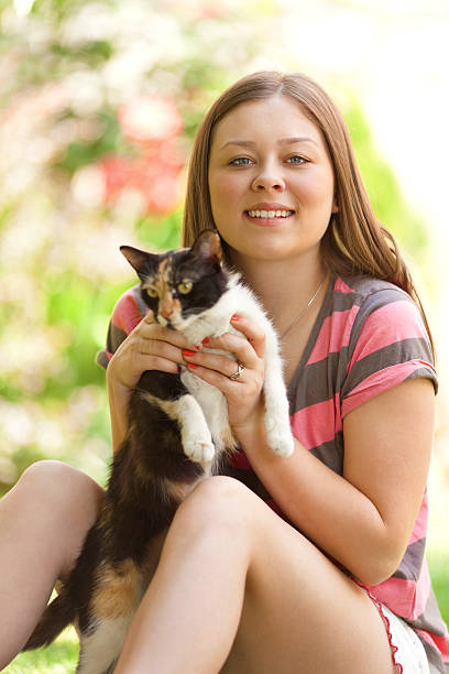 istock Young girl plays with cat 492533537