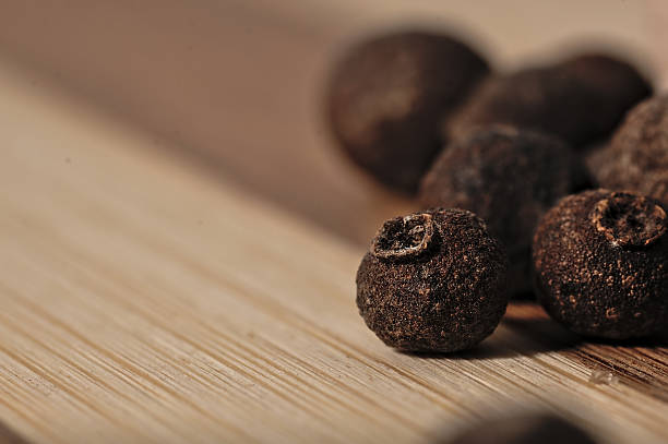 istock Grains allspice on a wooden board. 492537018