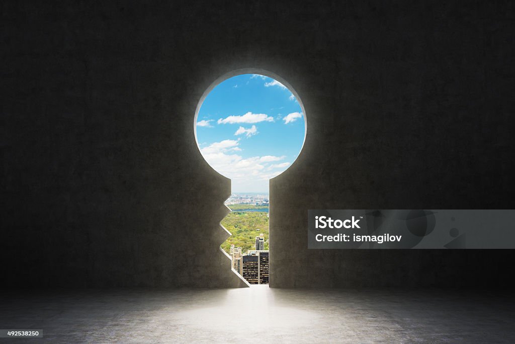keyhole in concrete wall. New York City view in hole. A keyhole in the concrete wall. New York City view in the hole. Unlocking Stock Photo