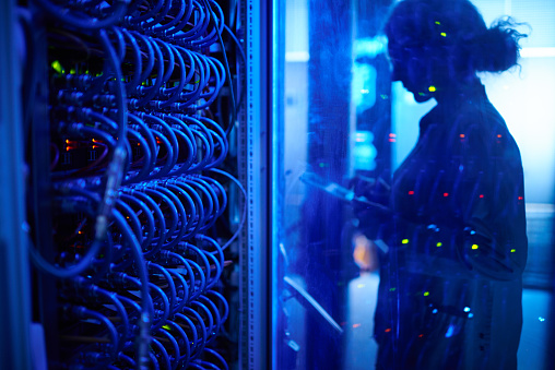 Woman is working late in server room