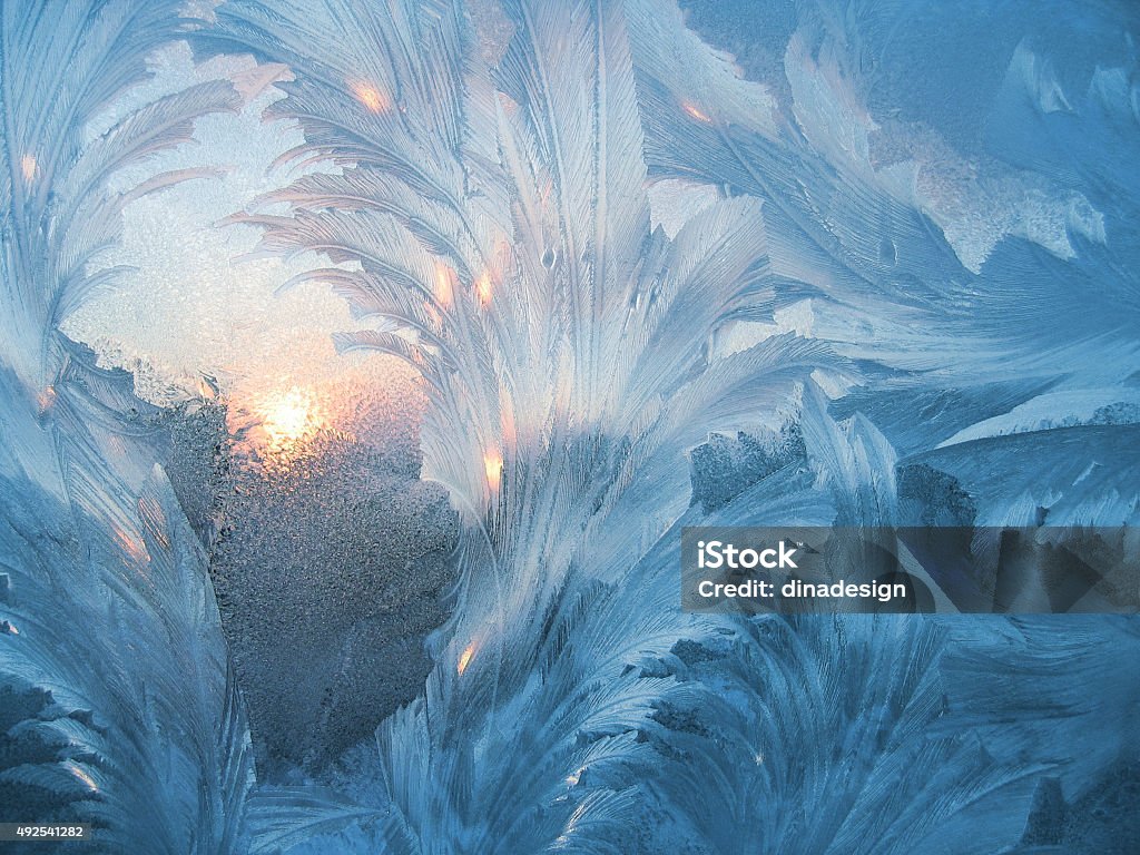 Ice pattern and sun Ice natural pattern and sunlight on winter window Winter Stock Photo