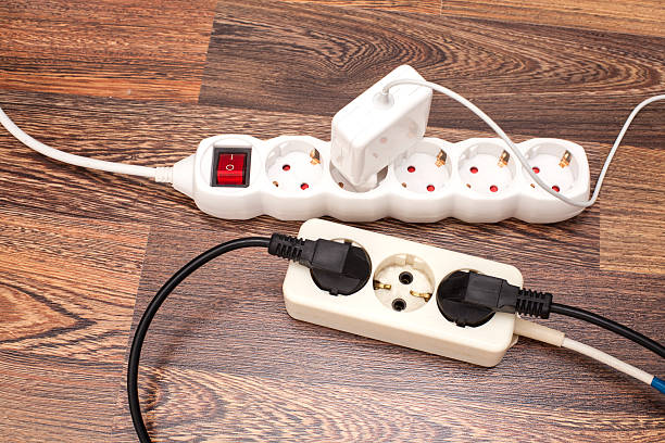 istock Many plugs plugged into electric power bars on floor 492543342