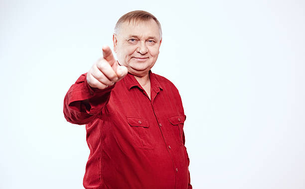 istock Senior with finger pointing at you 492543928