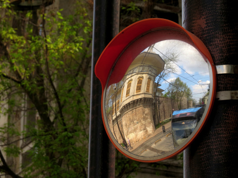 Train seen from a convex mirror in historical Gulhane District of Istanbul, Turkey