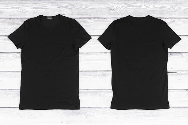 istock Two black blank T-shirts on a white wooden background 492546810