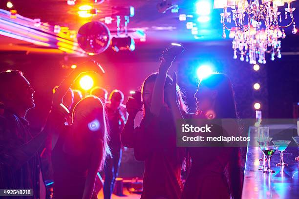 Dancing With Smartphones Stock Photo - Download Image Now - 2015, Adult, Alcohol - Drink