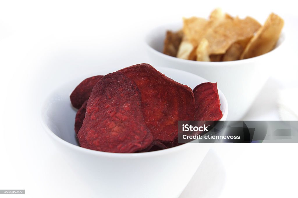 Two bowls of fried root vegetable chips. Appetizer Stock Photo