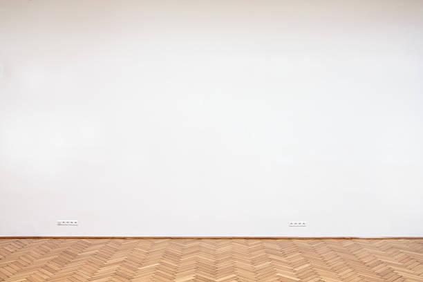 istock Large white wall with wooden floor tiles 492549333