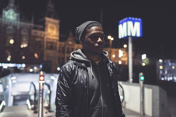 istock Man with woolen cap at subway station at night. 492549404