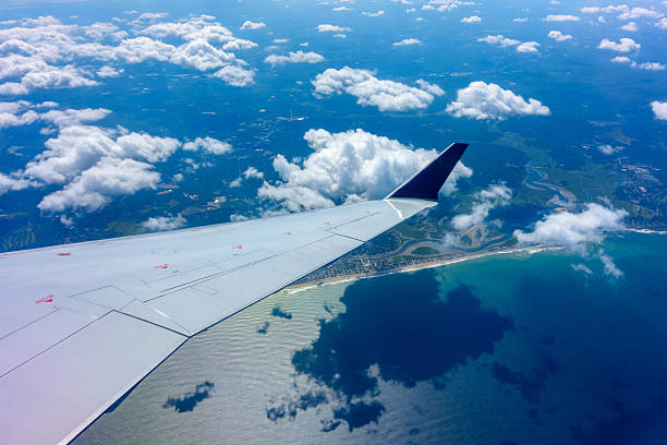 istock Wing of an airplane in flight 492551930